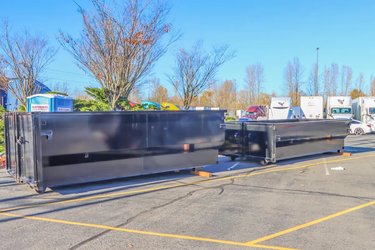 Professional dumpster rental service with roll-off container on residential driveway in Guntersville